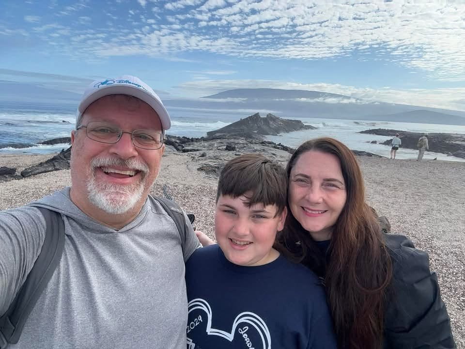 Herring family wearing Mickey Mouse attire on the volcanic shores of the Galapagos Islands