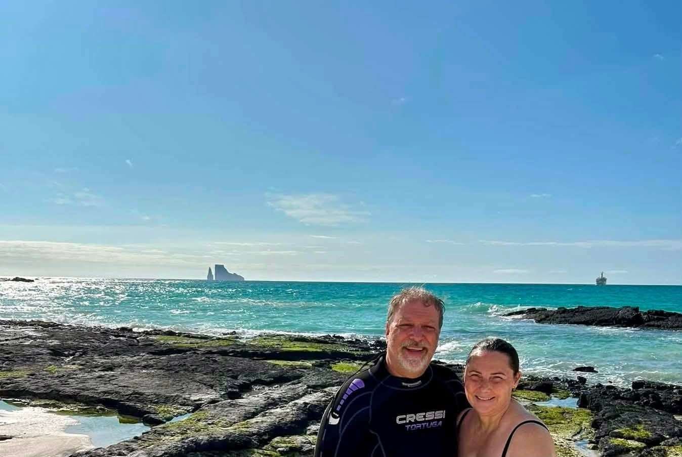 Johnnie Herring and her husband in wetsuits smiling after snorkeling with sharks, sea turtles, and rays