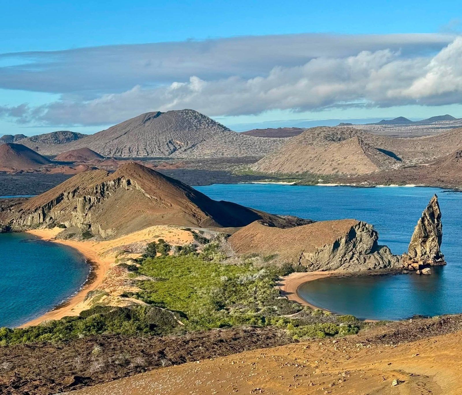 Panoramic overlook of Pinnacle Rock, twin crescent bays, and volcanic cones on Bartolome Island