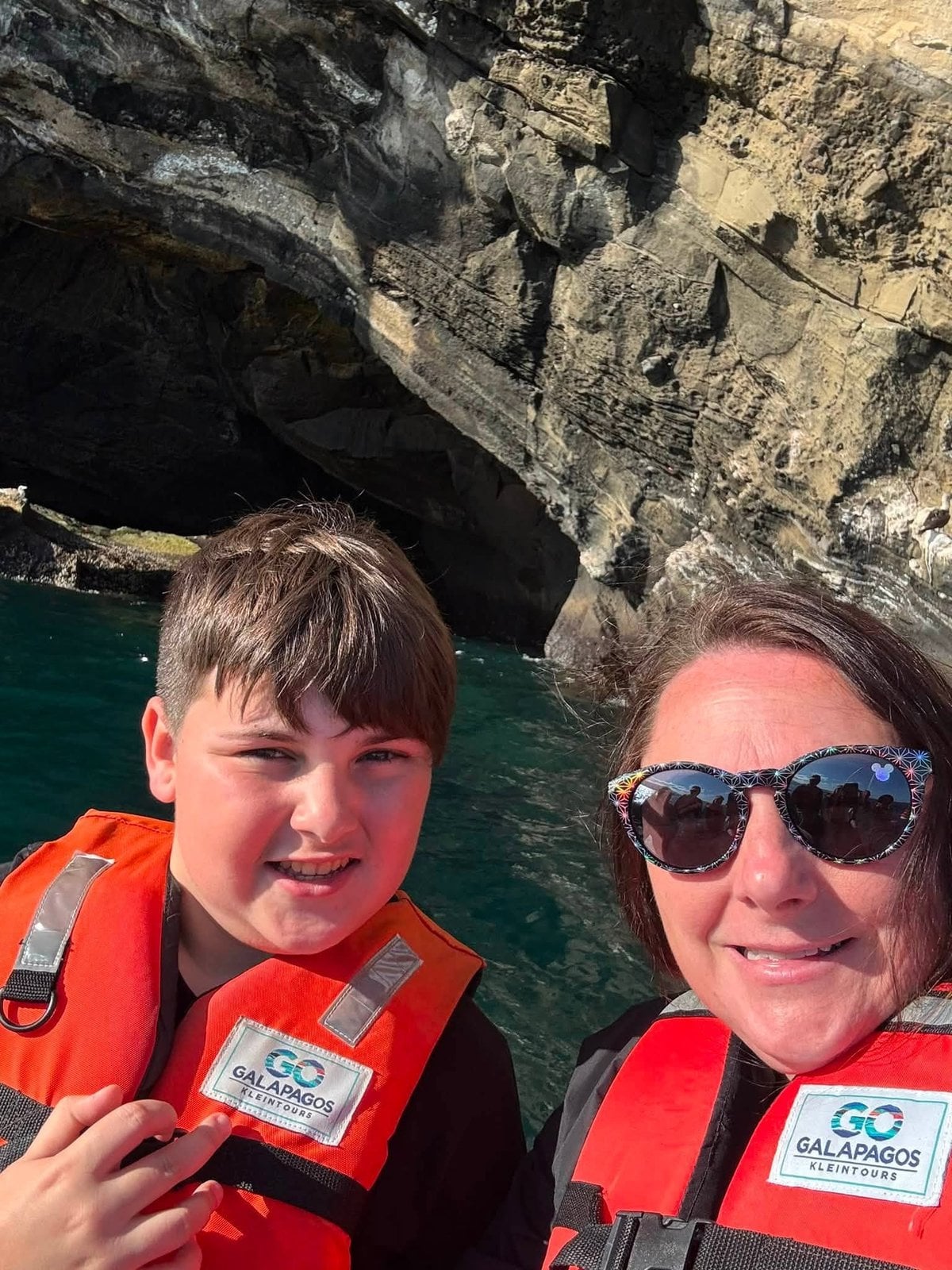 Johnnie and her son suited up in life vests for a Zodiac panga wildlife excursion