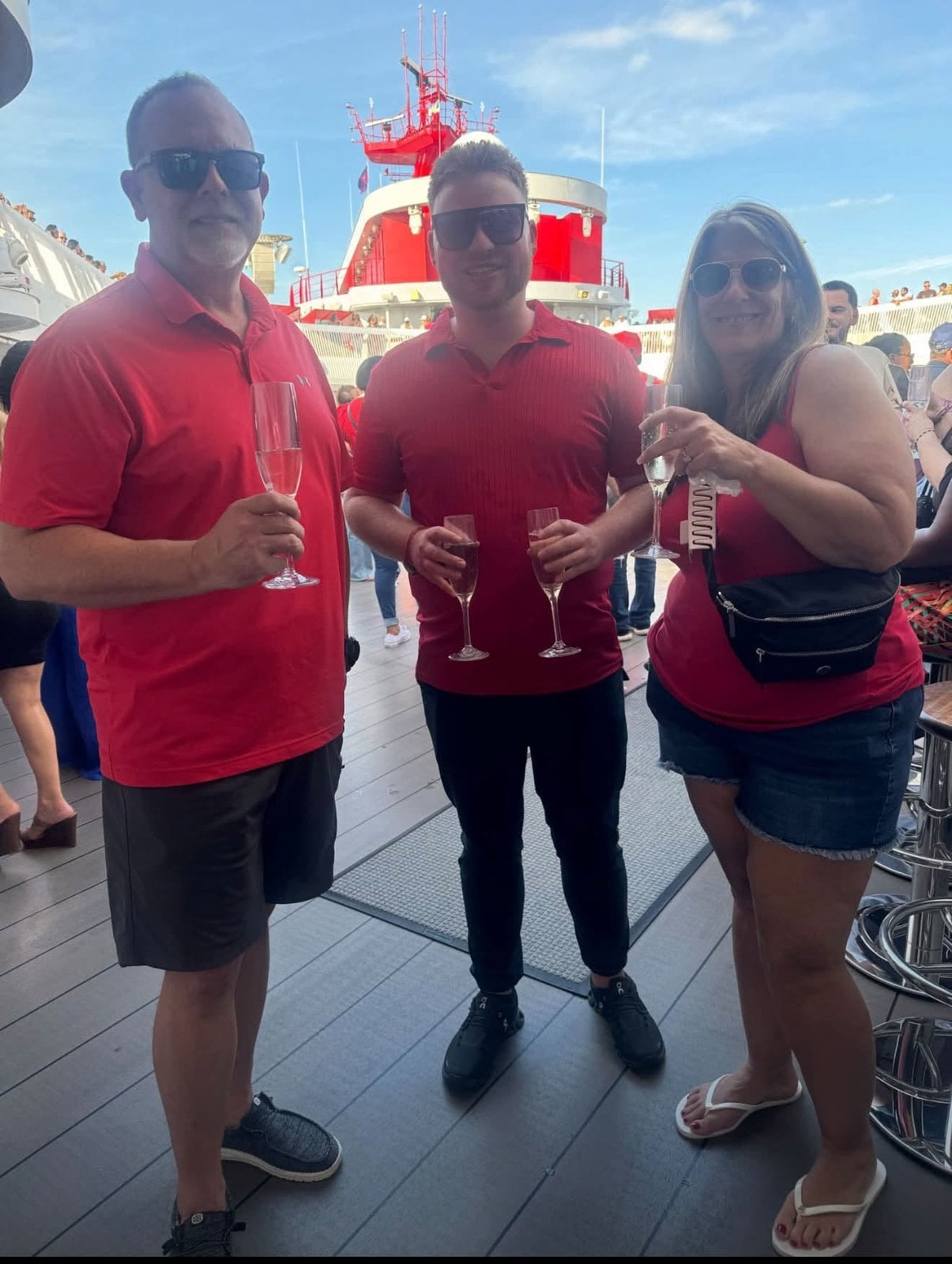 Logan White and family toasting with champagne at the Scarlet Lady Sail Away party