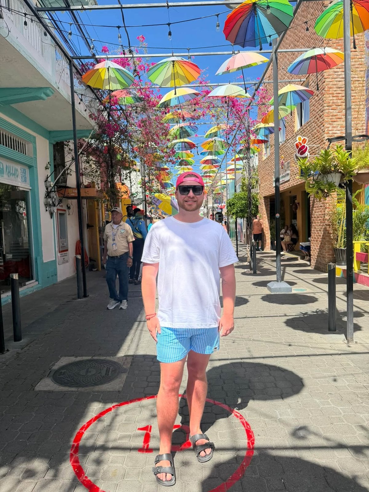 Logan White exploring colorful Umbrella Street in port