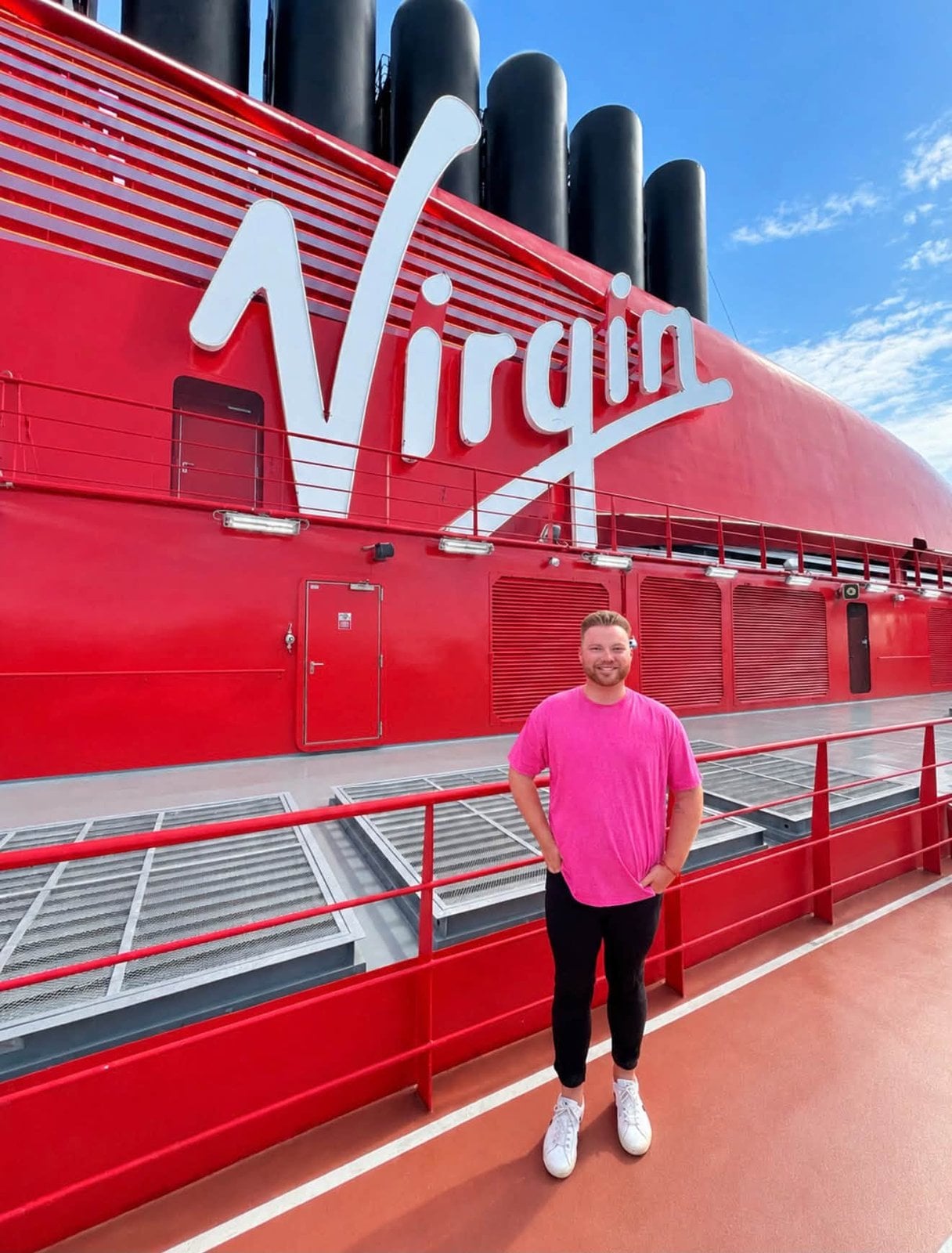 Logan White on the top deck beneath the signature red Virgin Voyages funnel
