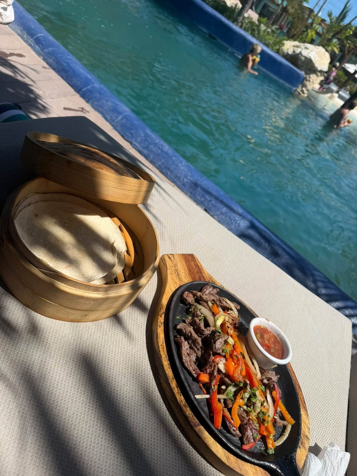 Poolside sizzling fajitas and warm tortillas in the sunshine
