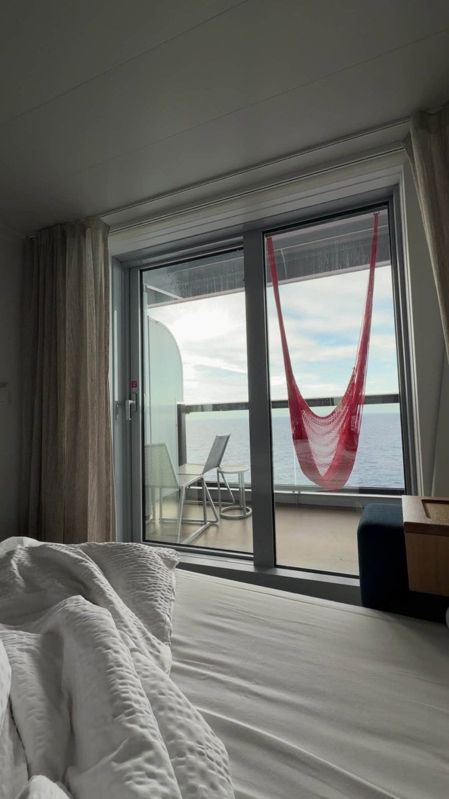 View of the red woven hammock on the Sea Terrace balcony overlooking the ocean
