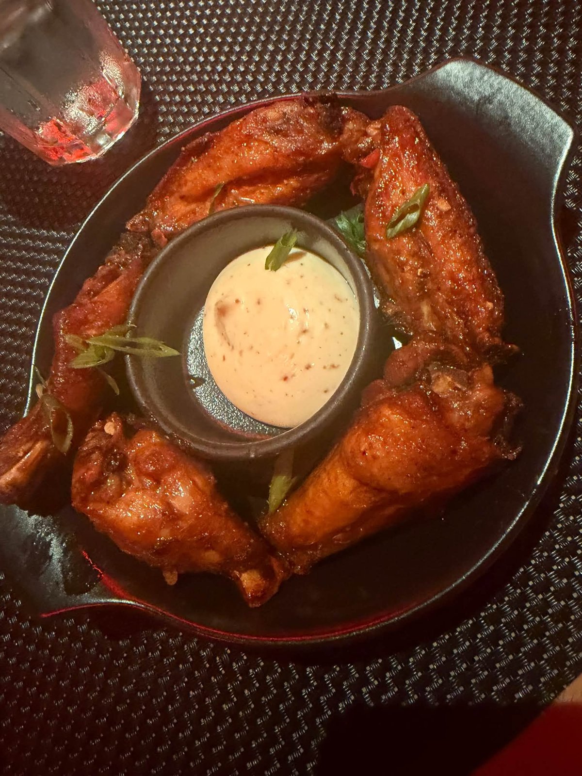Crispy glazed chicken wings at Virgin Voyages specialty restaurant