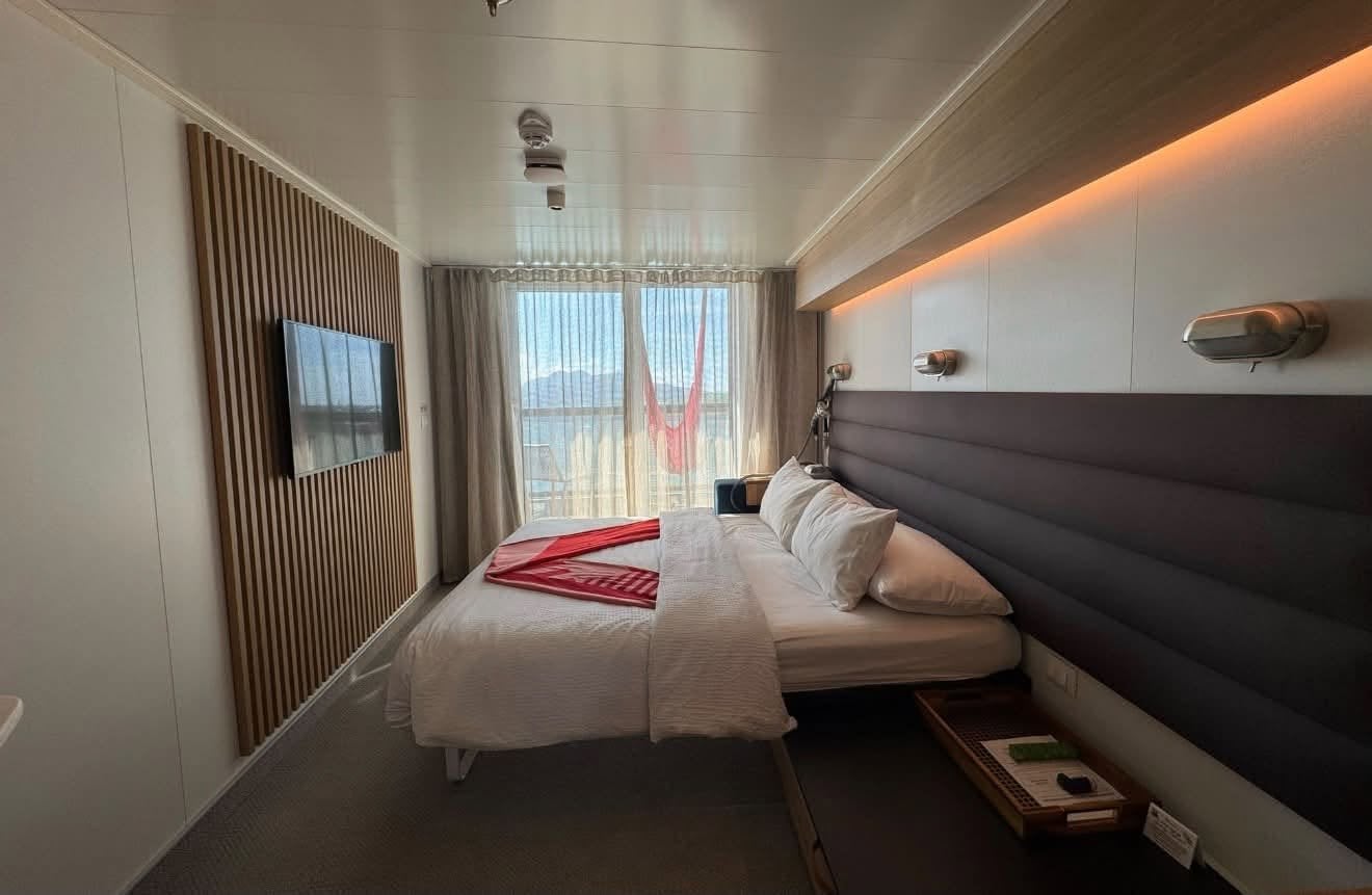 Inside Logan White's Sea Terrace balcony cabin aboard Scarlet Lady