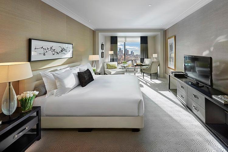 Premier King Room featuring bespoke timber cabinetry, chaise lounge, and marble ensuite