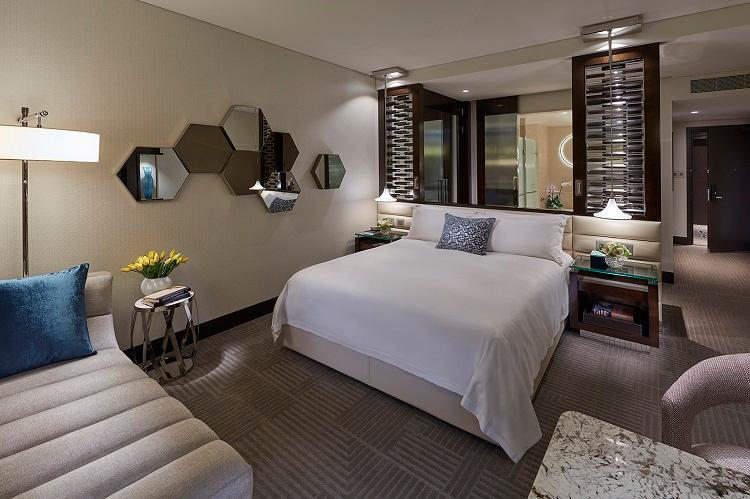Deluxe King Room featuring custom textiles and modern marble bathroom