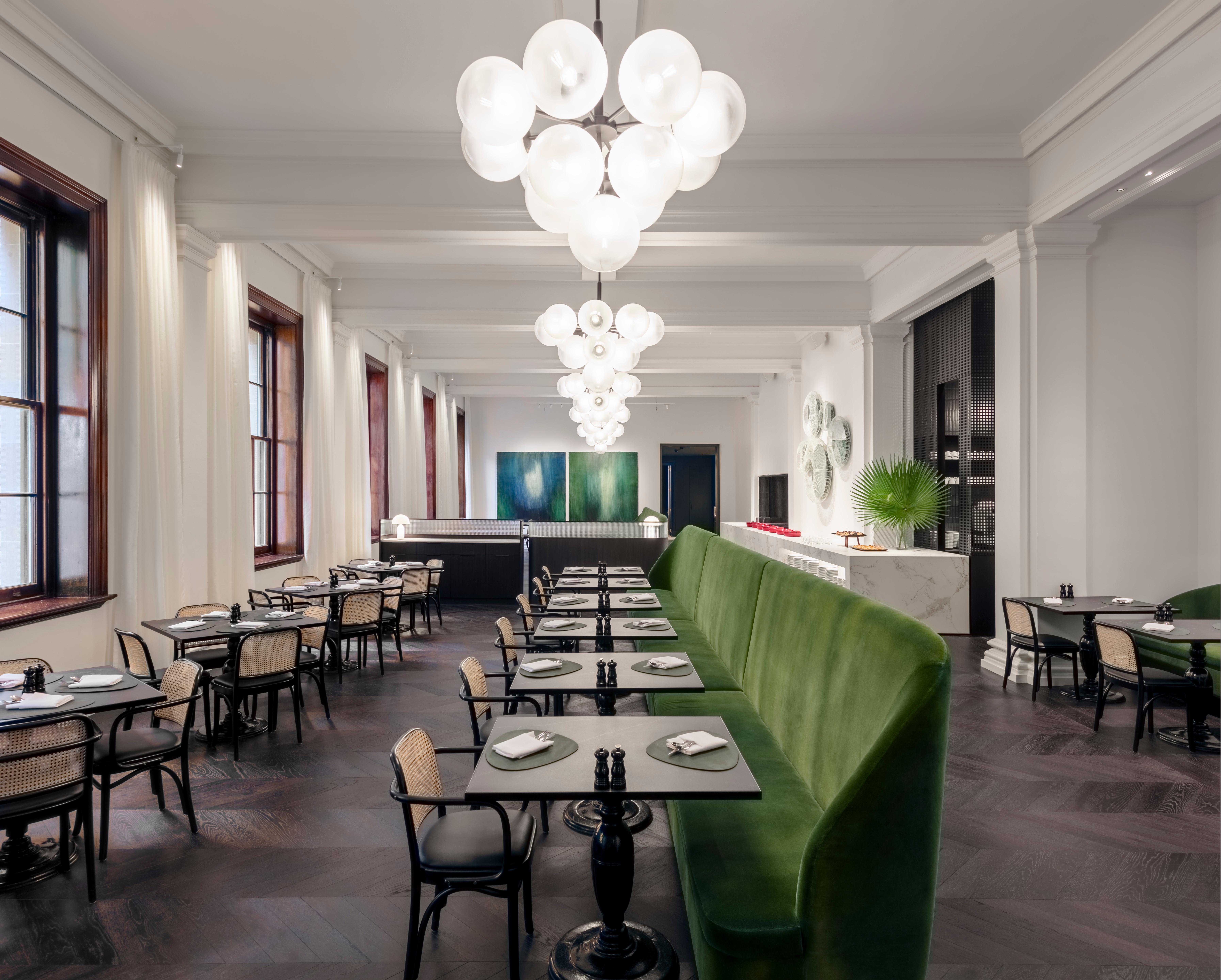 The Conservatory breakfast restaurant filled with natural daylight and lush greenery