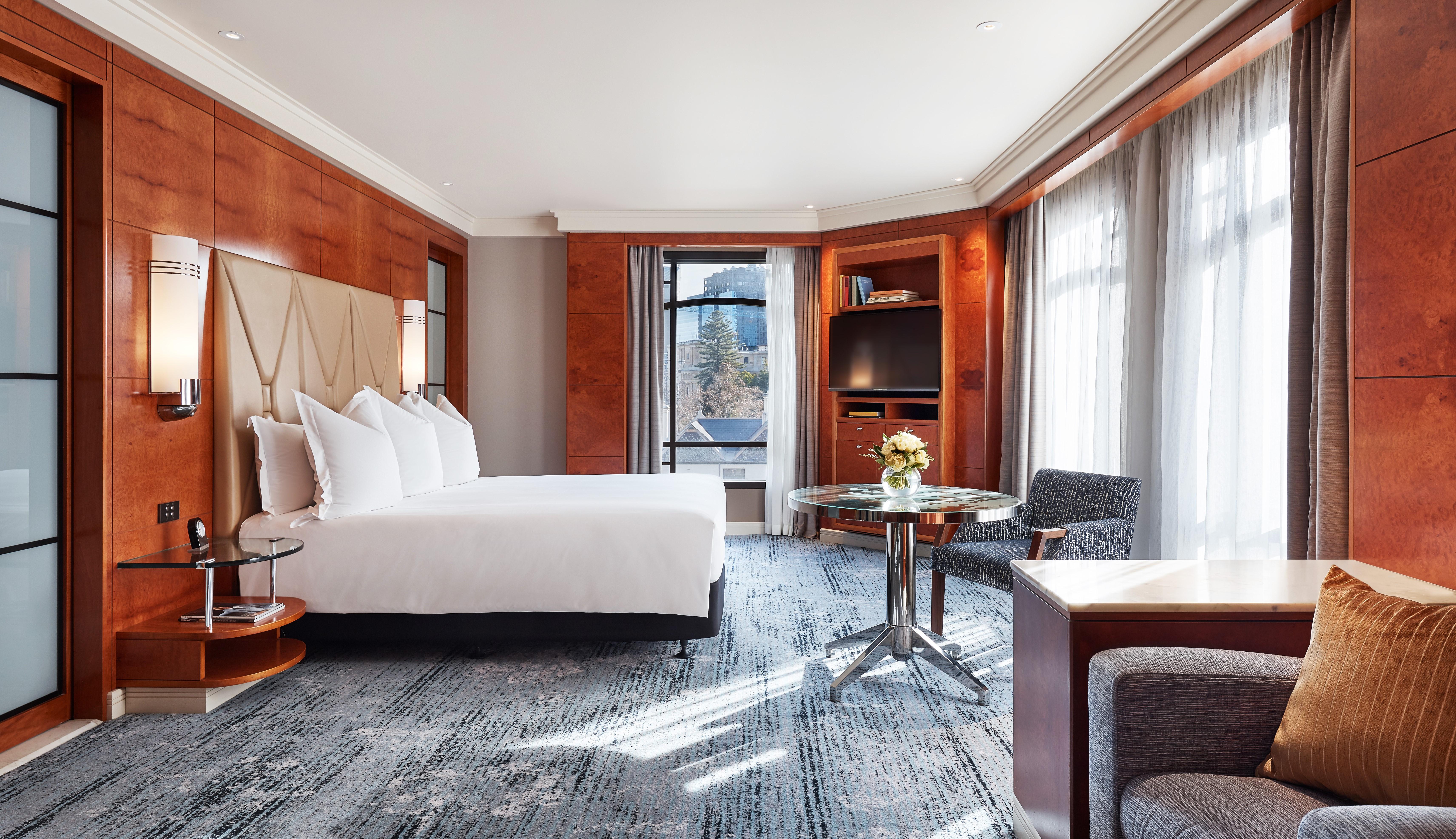 Spacious 60-square-meter King Deluxe guestroom with rich Madrona burr wood and plush king bed