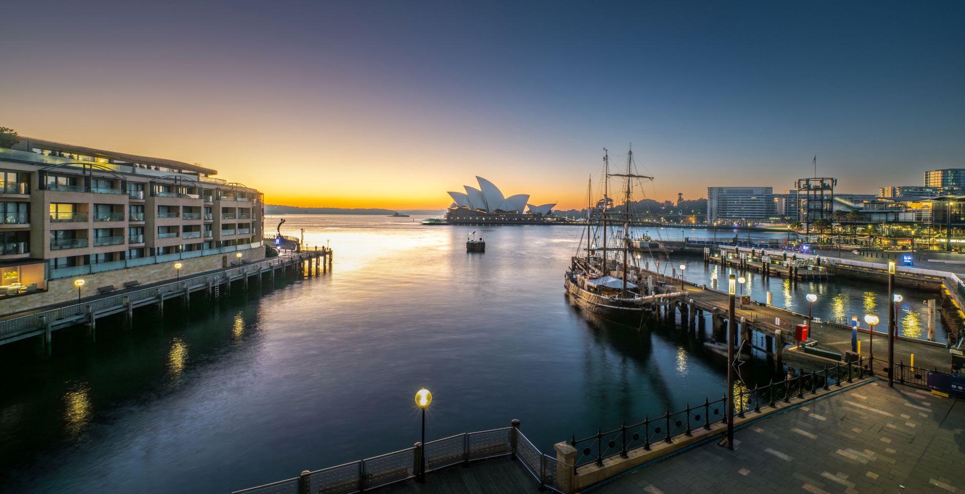 Private room balcony framing an intimate sunrise view of the Sydney Opera House sails