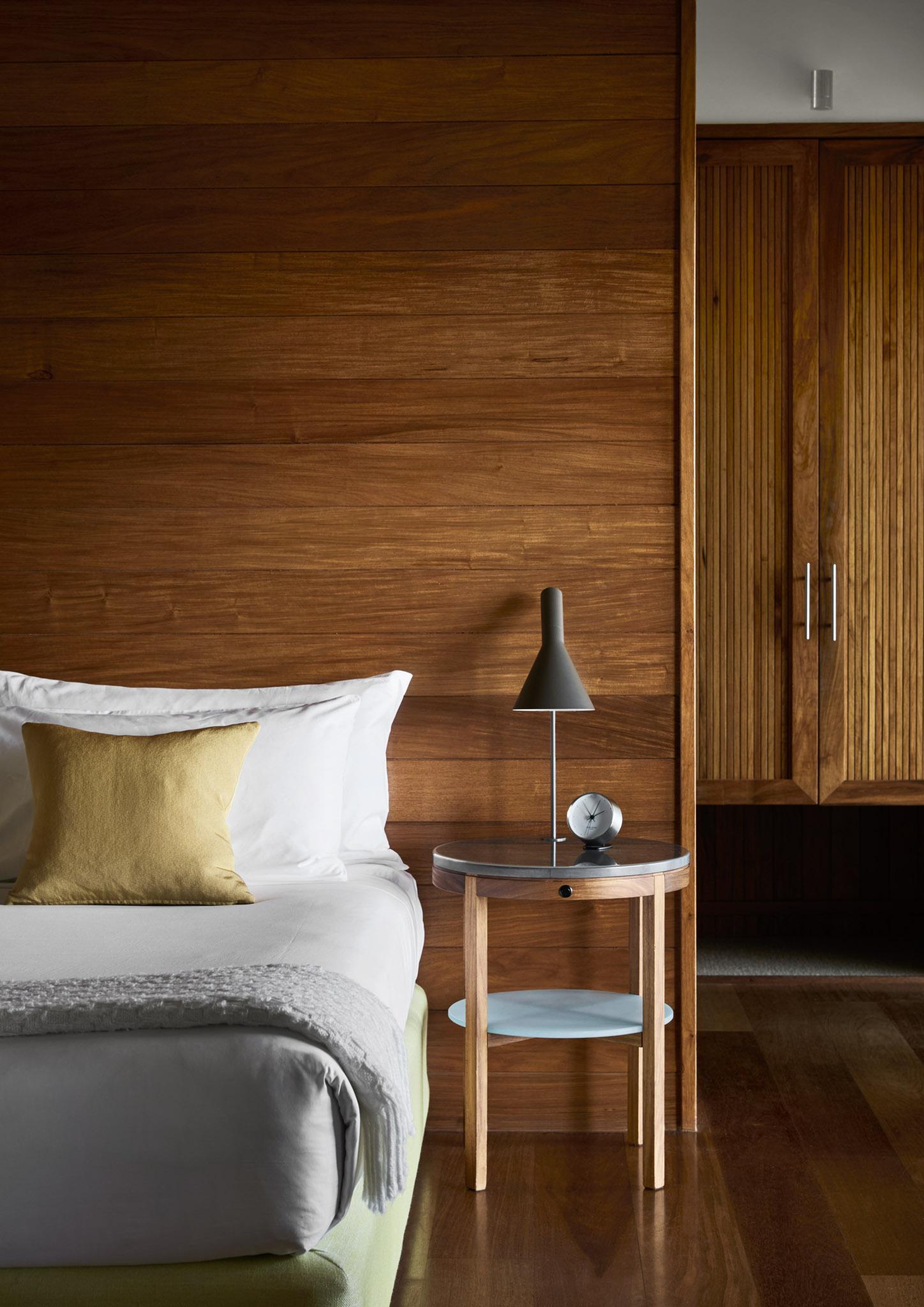 Leeward Pavilion open-plan king bedroom featuring natural timbers and stone with Coral Sea views