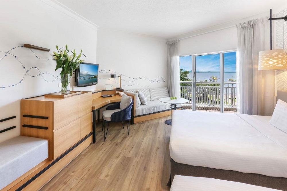 Deluxe Sea View Room with twin beds, private balcony, and Trinity Inlet Coral Sea vistas