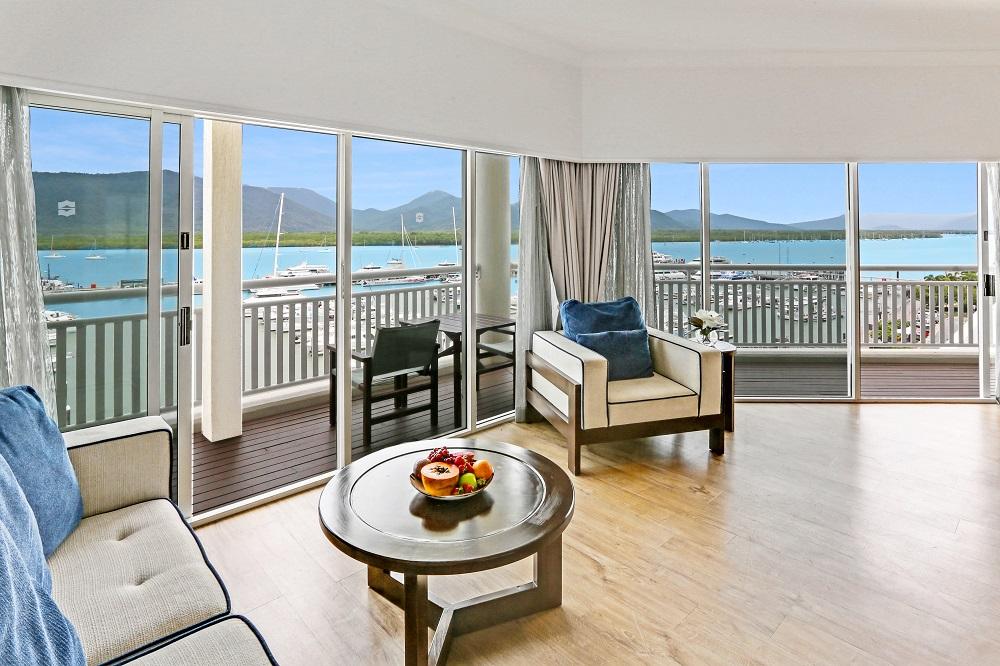Executive Marina Suite spacious living salon with floor-to-ceiling glass and private balcony