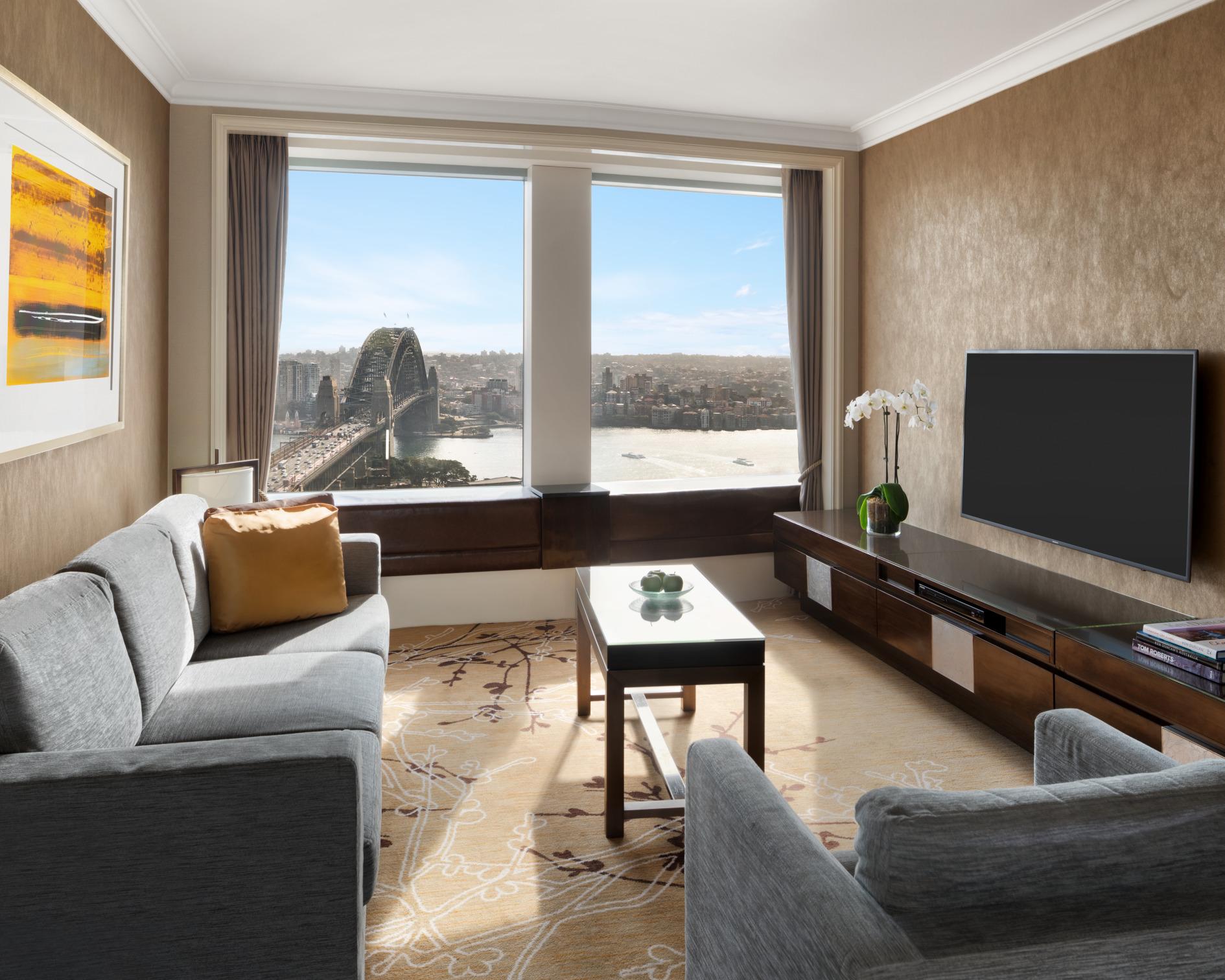 Sydney Harbour Suite luxurious living salon with plush furnishings and floor-to-ceiling harbour views