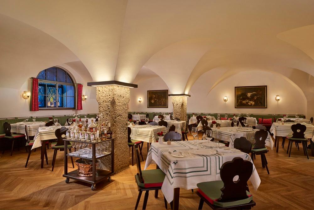 Restaurant Goldener Hirsch fine dining room overlooking Karajanplatz