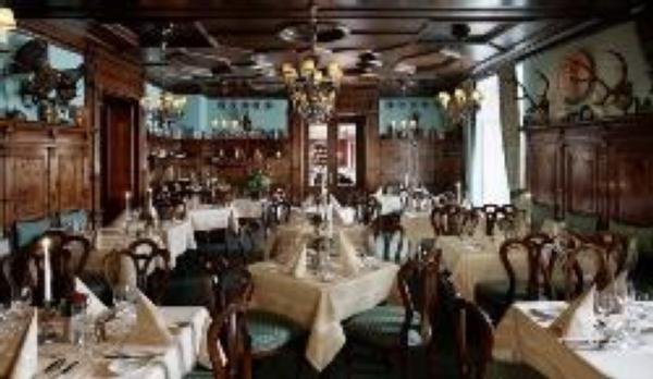 Historic fine-dining restaurant Zirbelzimmer clad in authentic Swiss stone pine