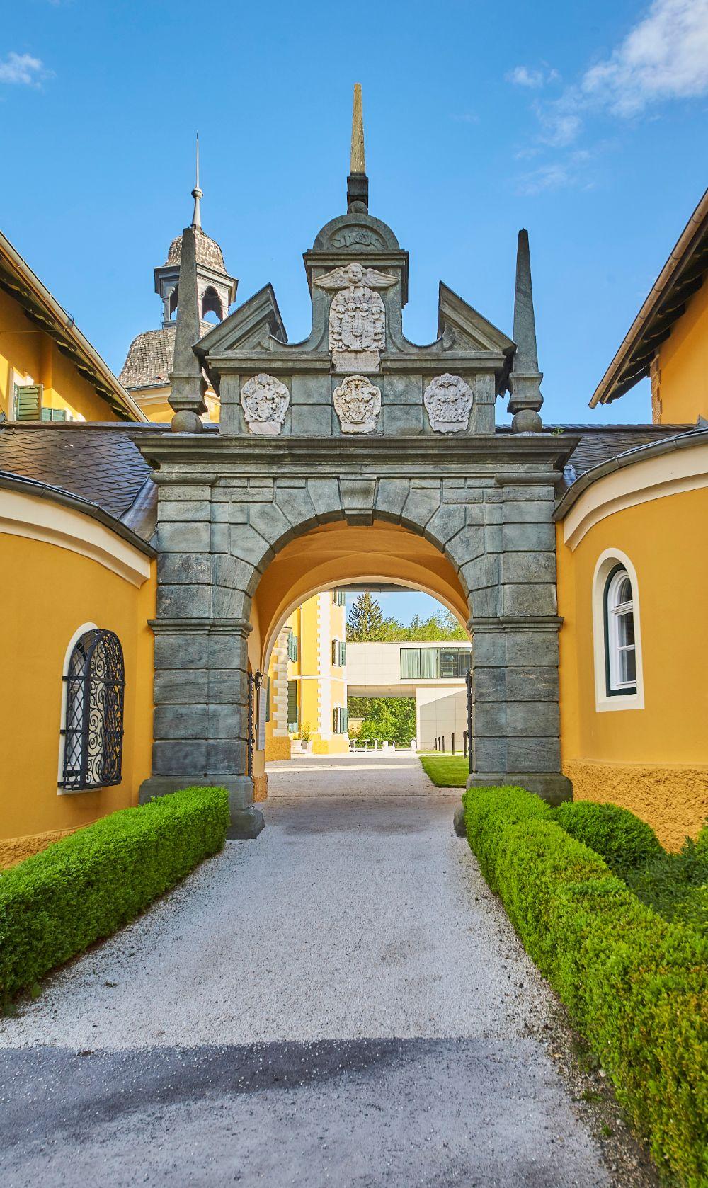Grand historic palace entrance and courtyard gardens