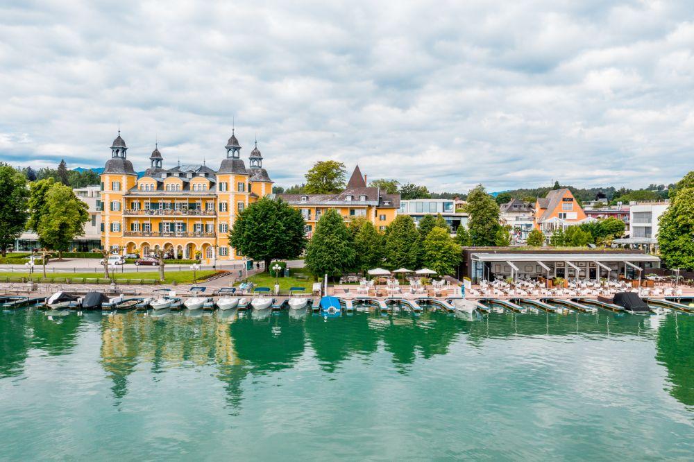 Iconic yellow Renaissance chateau viewed from the turquoise waters