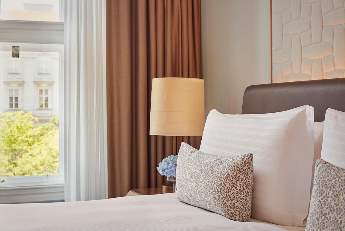 Deluxe guestroom with marble bathroom, featherbed, and Austrian palace flair