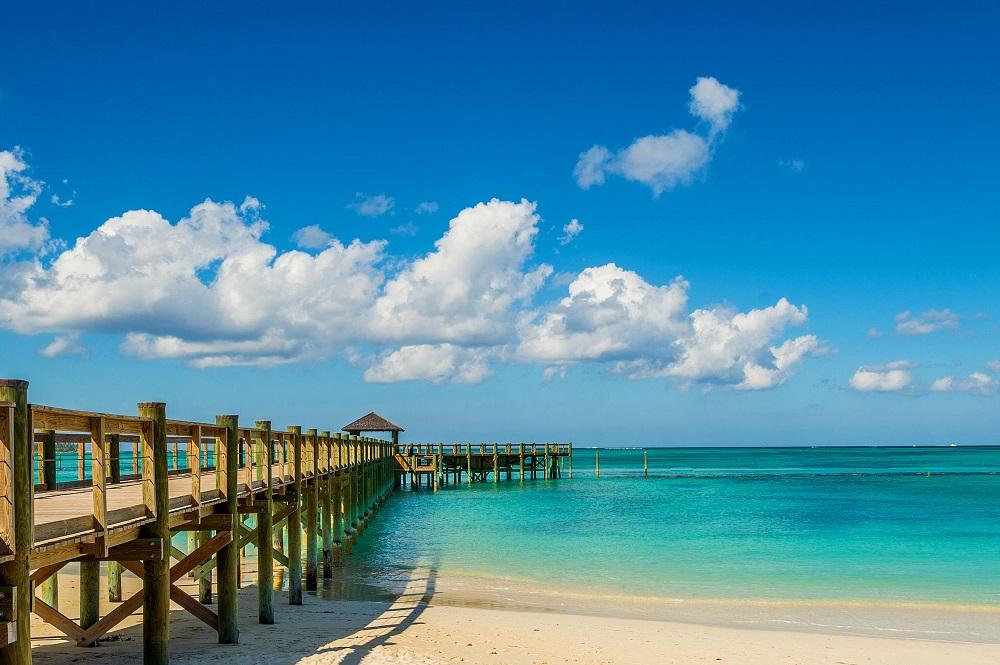 Pristine white sands and turquoise shallows of Cable Beach with loungers