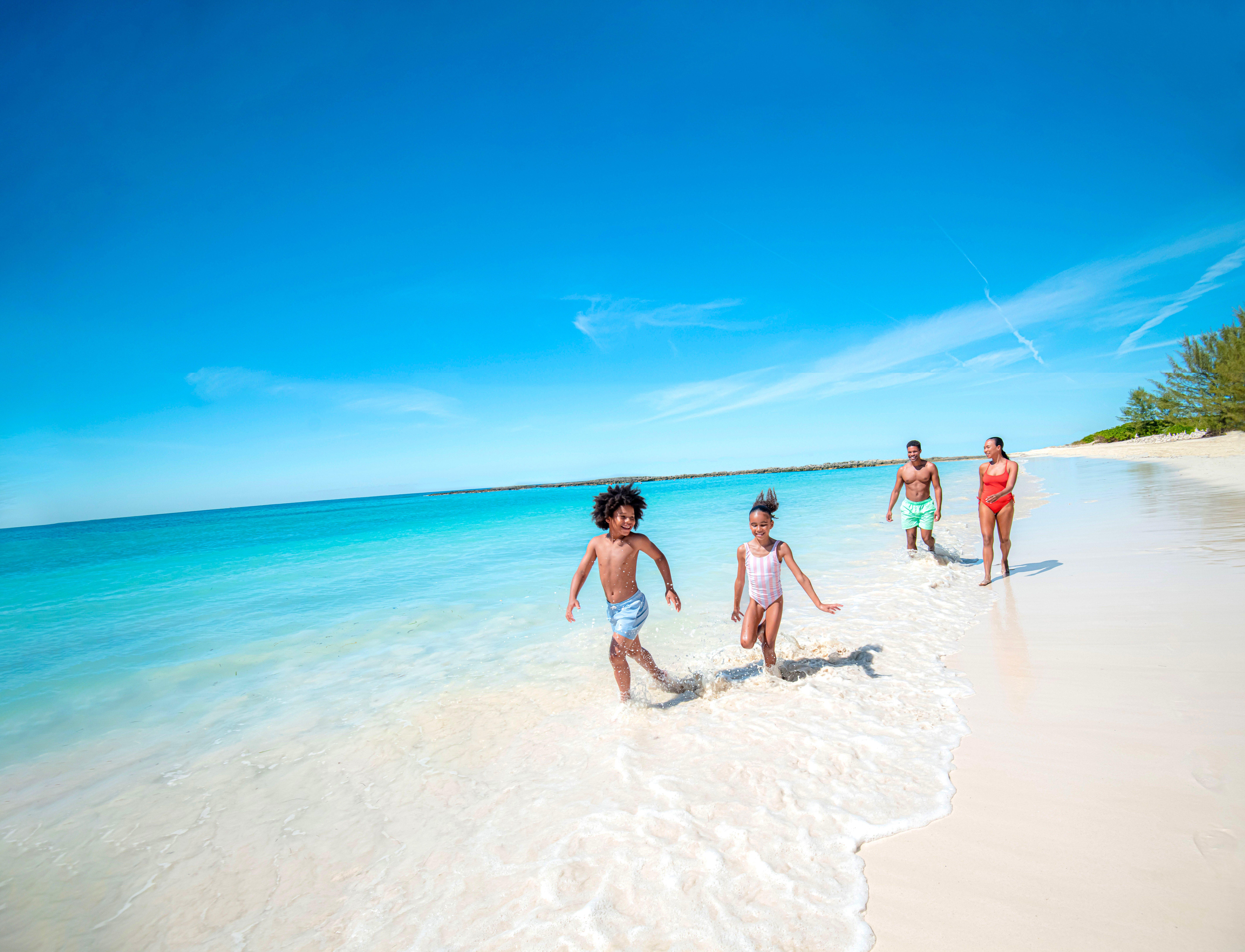 Families enjoying the powdery sands and turquoise waters of Paradise Beach
