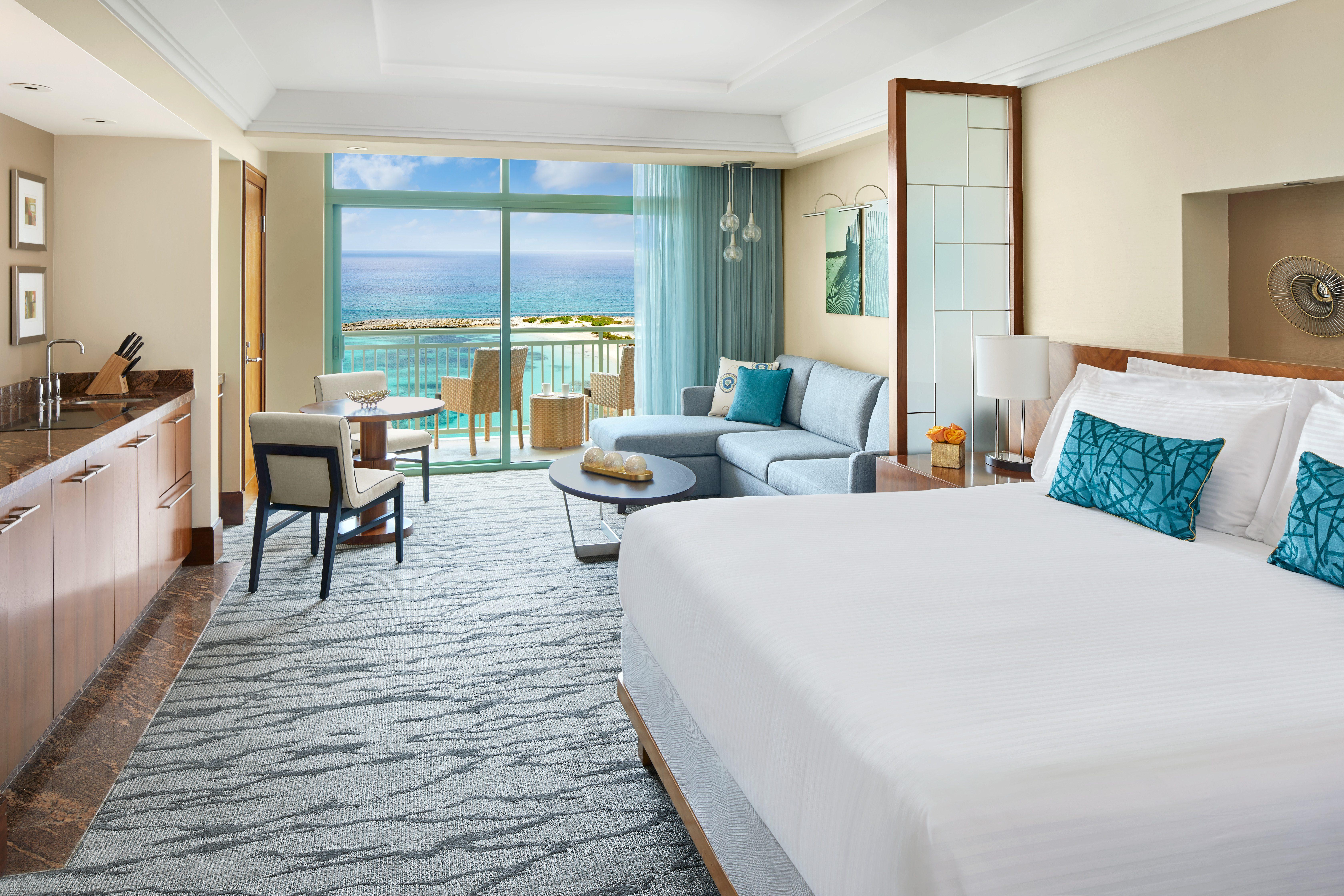 Studio Suite master bedroom with kitchenette and oceanfront balcony