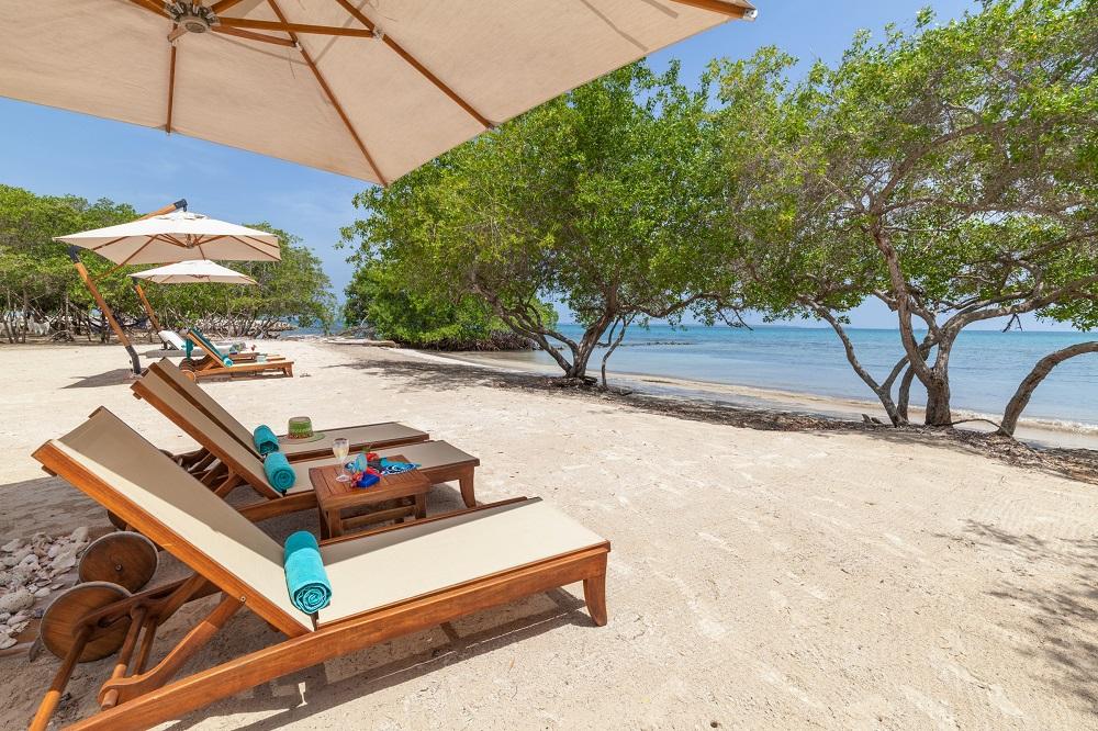 AcasÃ­ Private Beach Club daybeds and turquoise sea