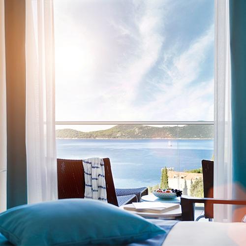 Deluxe Room with private furnished balcony framing sea views