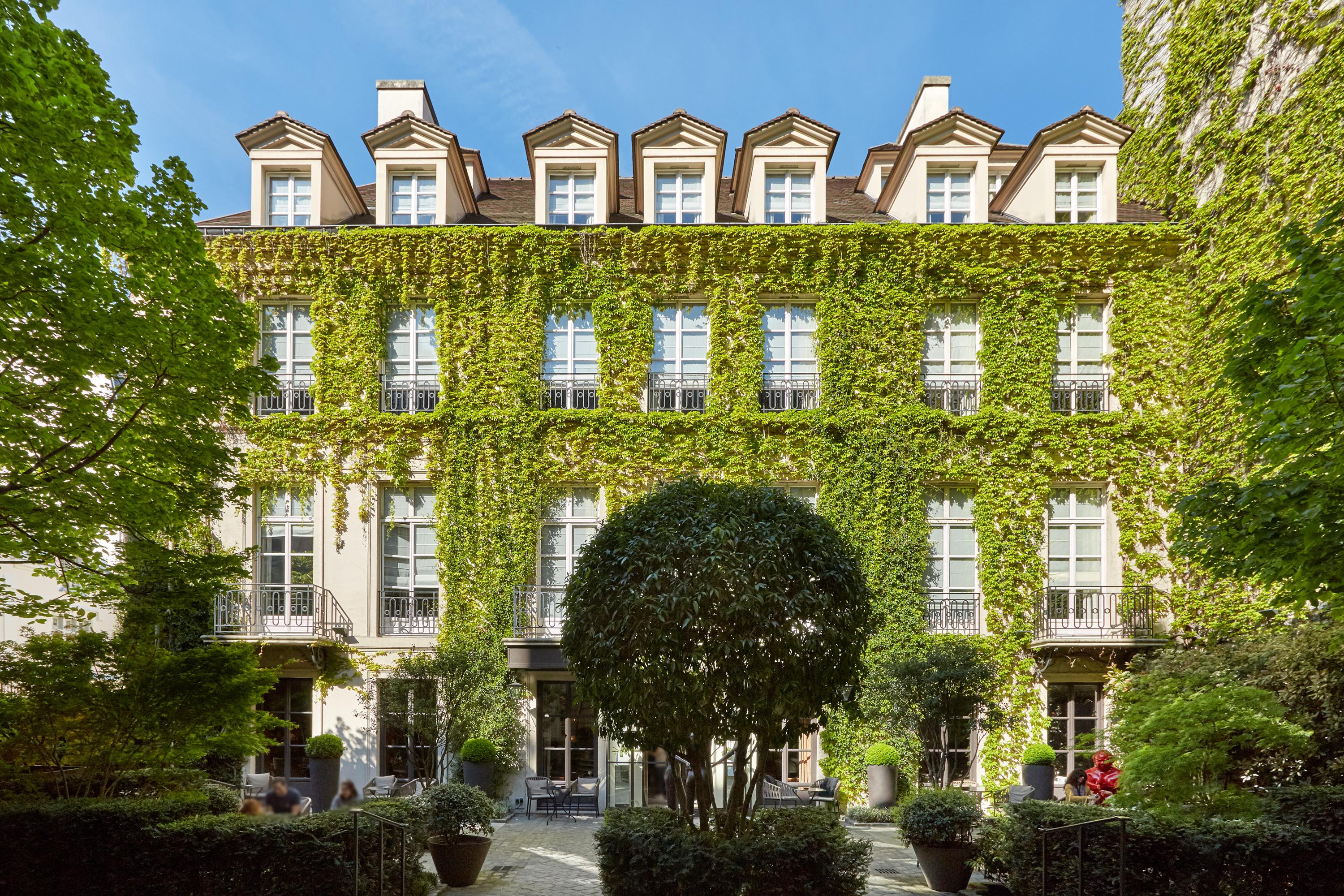 Pavillon de la Reine ivy-covered historic facade on Place des Vosges, Paris