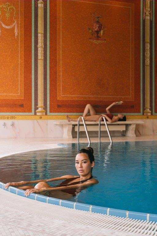 Indoor Roman-style swimming pool opening onto private parkland lawns