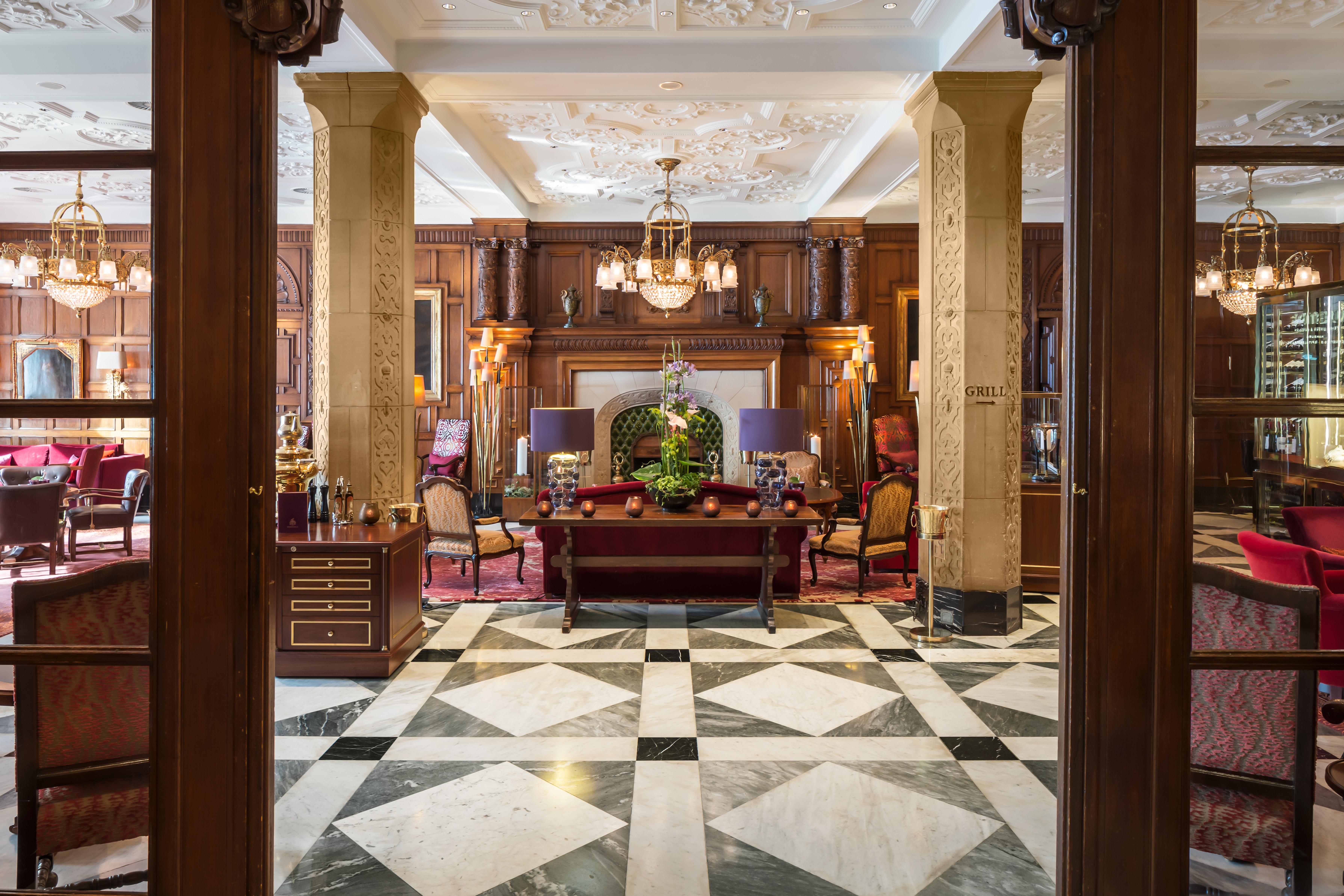 Wohnhalle grand salon with open wood fireplace and afternoon tea service