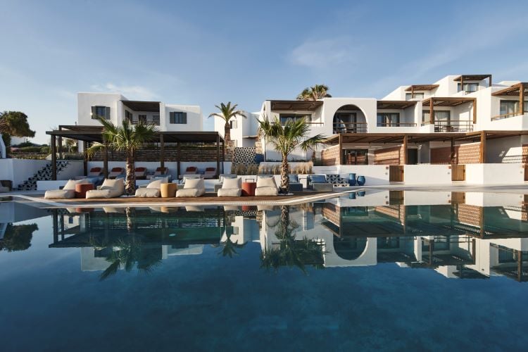 Andronis Minois whitewashed Cycladic architecture and turquoise pool facing the Aegean Sea