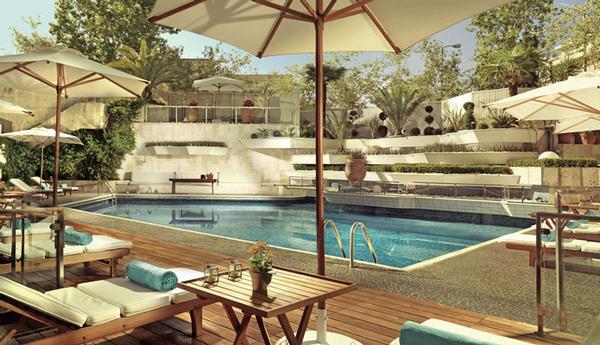 Tranquil outdoor swimming pool, sun loungers, and landscaped poolside oasis
