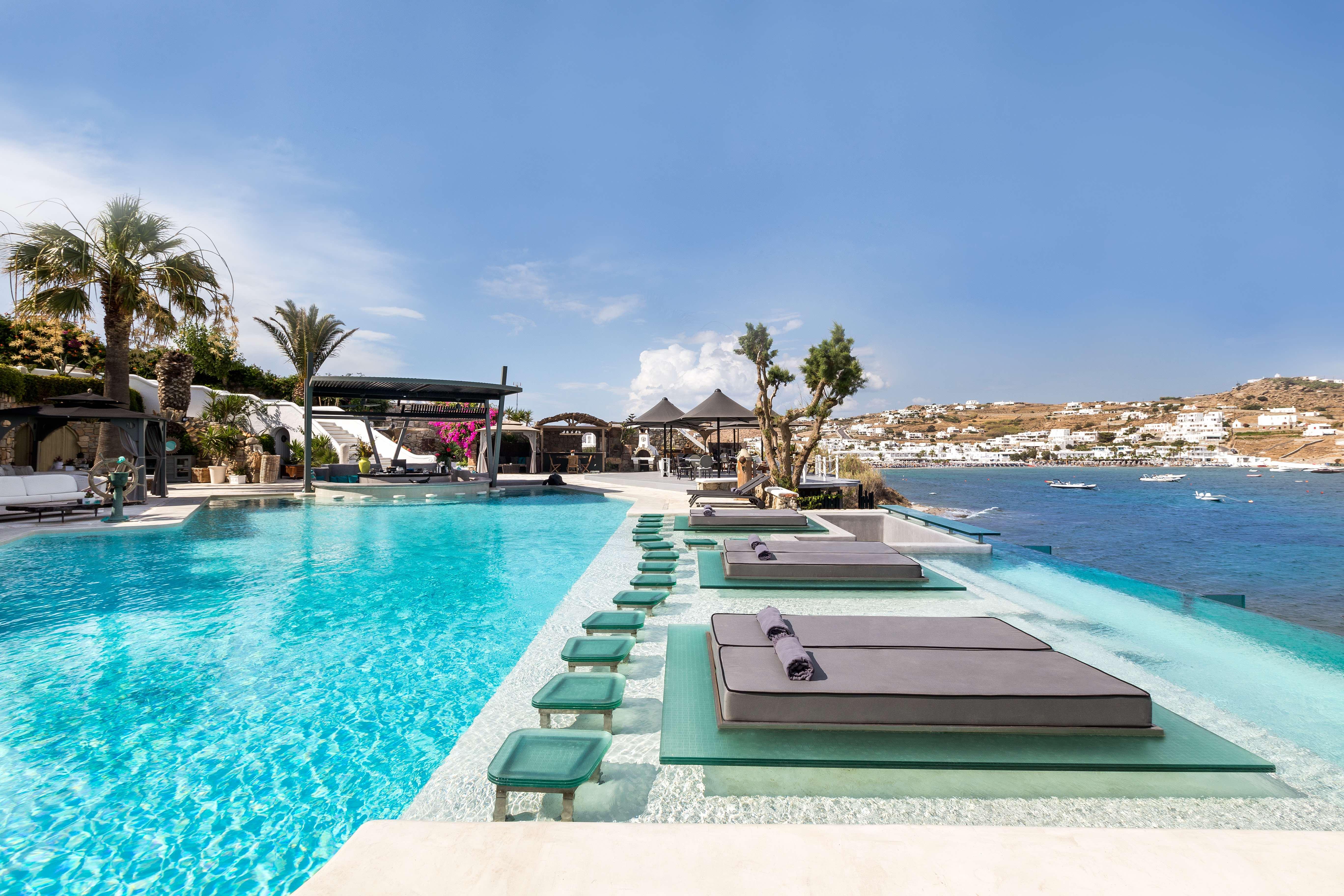 Kivotos Mykonos Seafront Main Pool and Sun Loungers Overlooking Ornos Bay