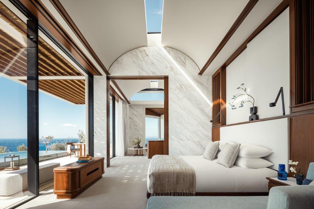 Cliff Villa Bedroom with Floor-to-Ceiling Aegean Windows and Local Stone Details