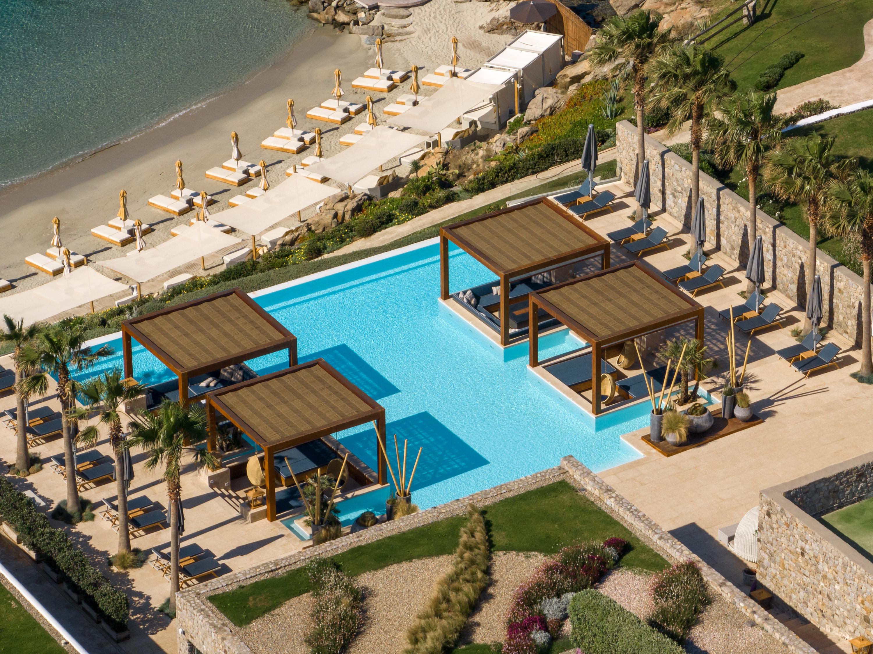 Oasis Seawater Infinity Pool with Floating Daybed Cabanas Facing Aegean Horizon
