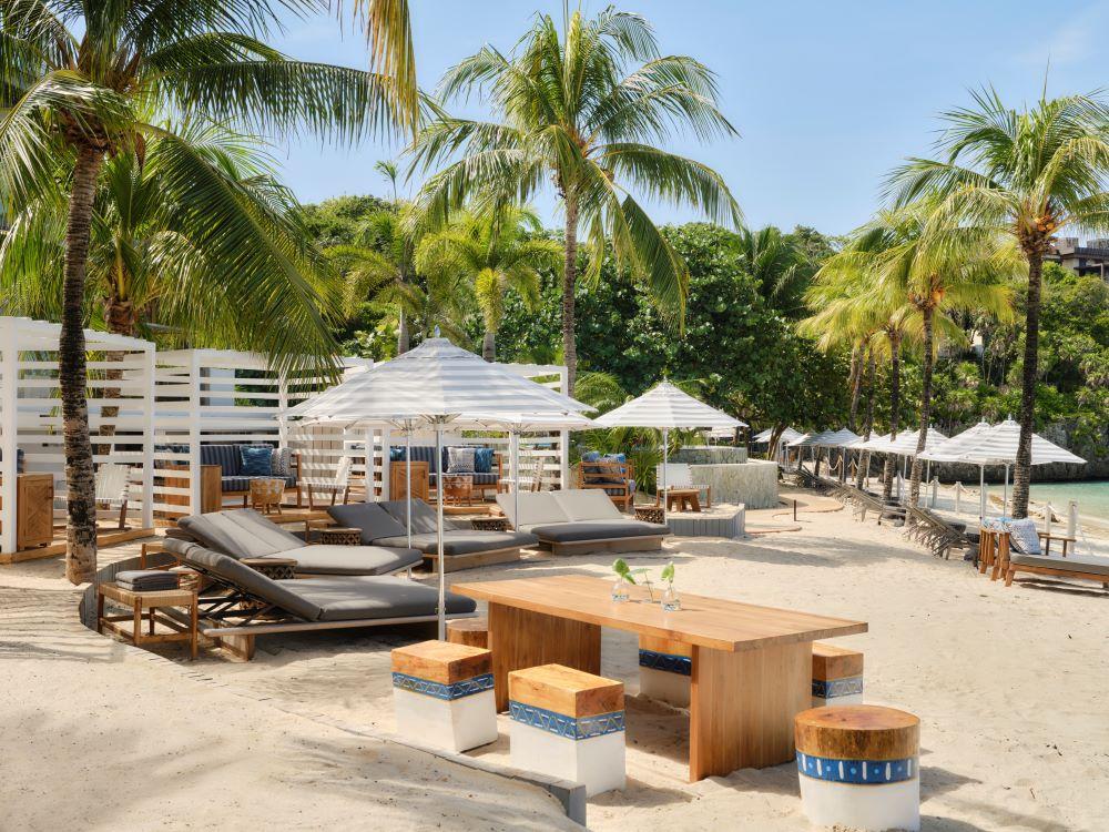 Private beach cabanas and powdery white sand at West Bay Beach along the coral reef