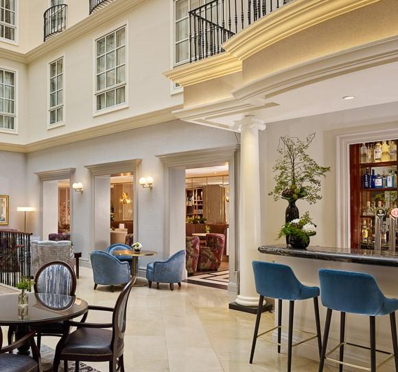 The Atrium Lounge Beneath Soaring Five-Storey Glass Roof for Signature Afternoon Tea