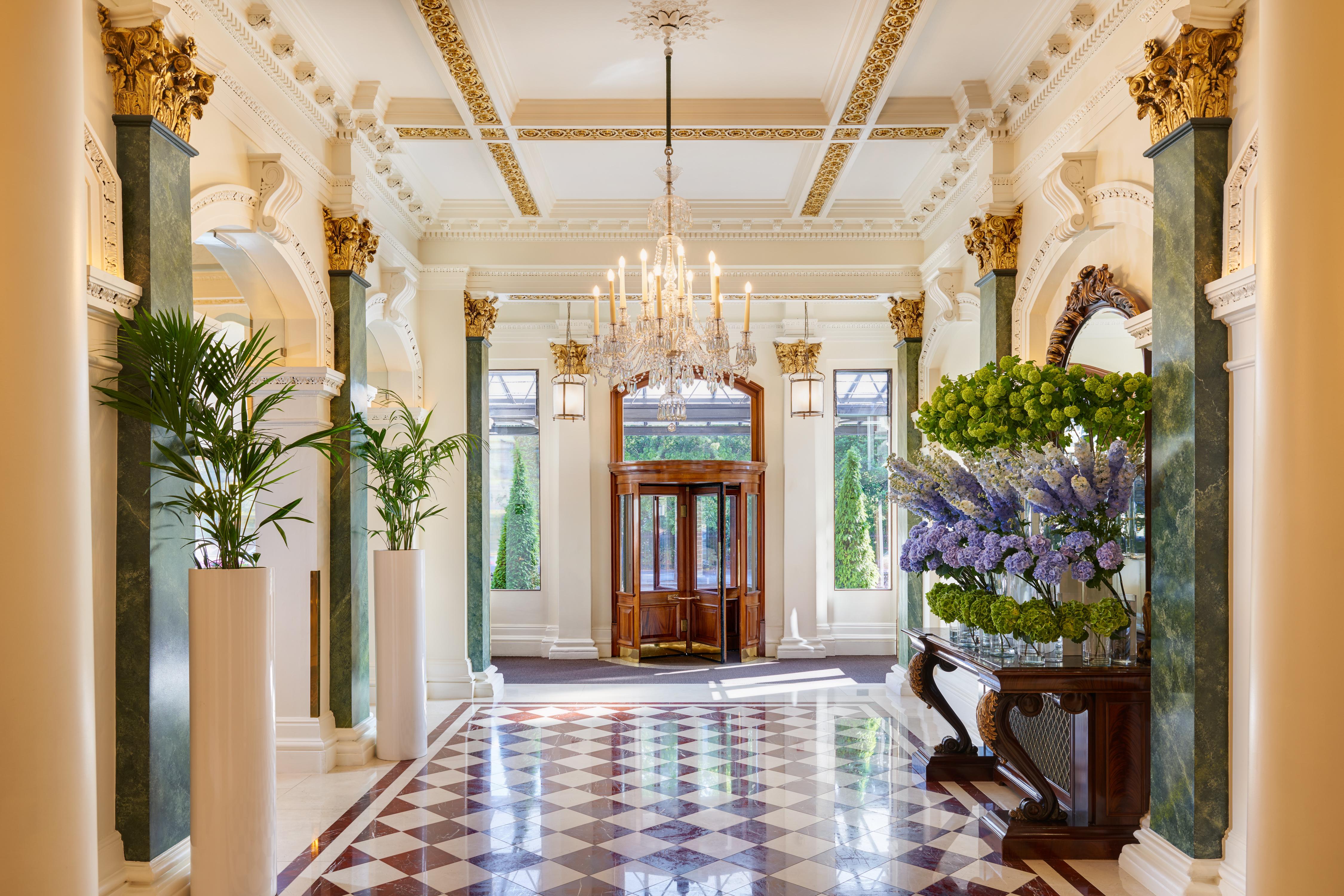 The Shelbourne Grand Lobby with Neoclassical Columns, Crystal Chandeliers, and Marble Floors