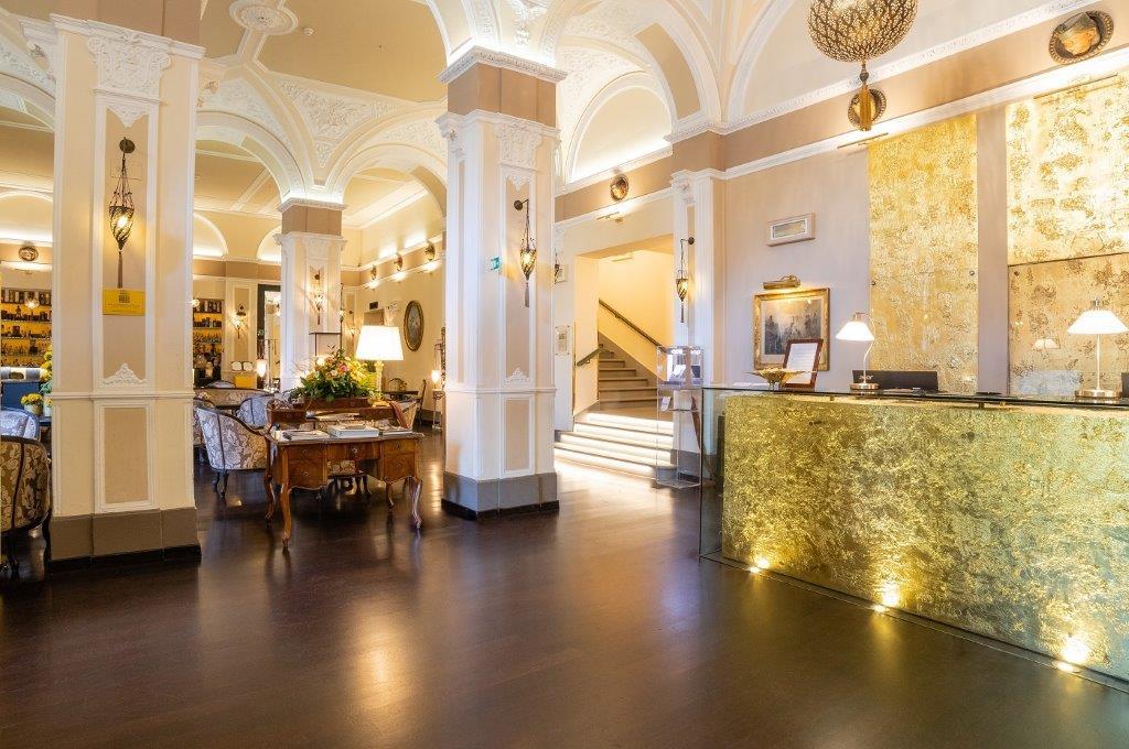 Stately Palace Lobby Featuring Renaissance Columns, Historic Tapestries, and Antique Seating
