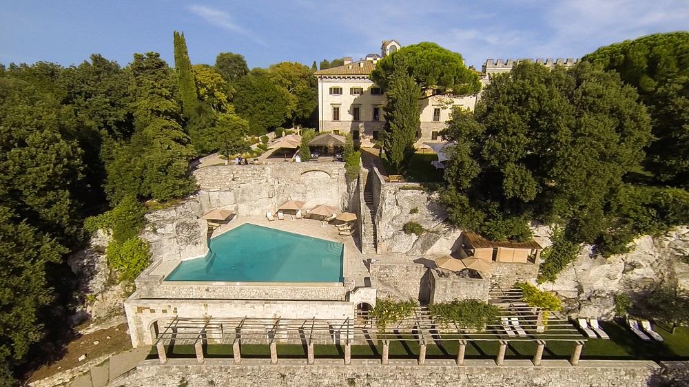 Borgo Pignano Travertine Infinity Pool Carved into Ancient Limestone Quarry in Tuscany