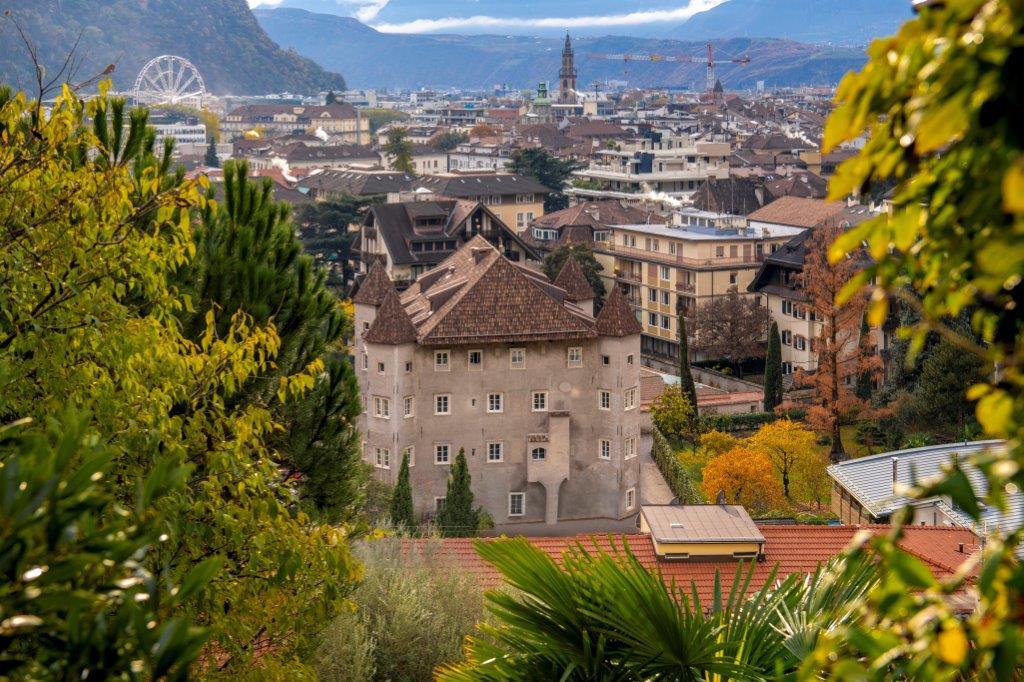 Outdoor heated pool surrounded by castle gardens in Bolzano
