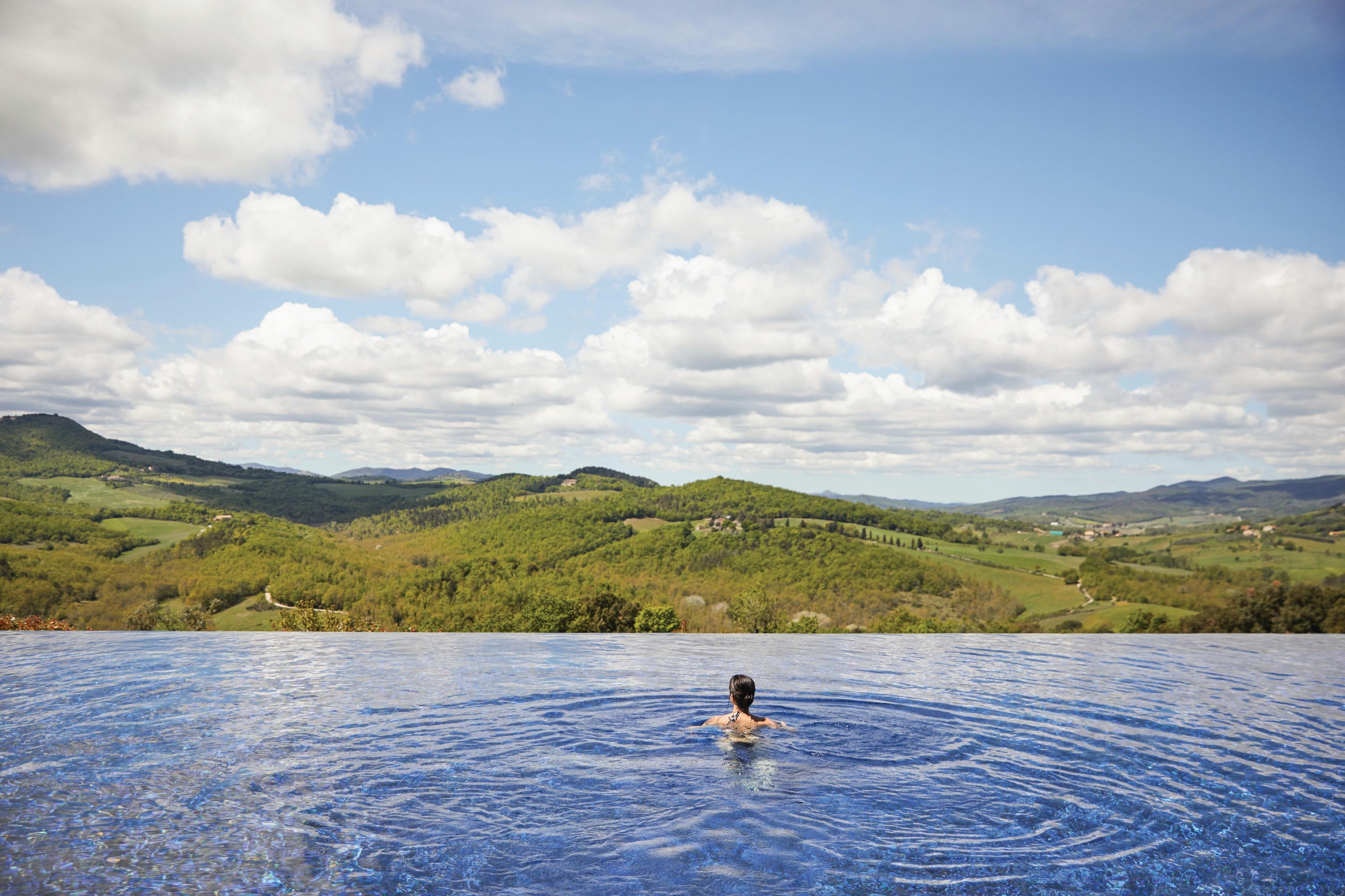 Heated outdoor infinity swimming pool overlooking Tuscan countryside