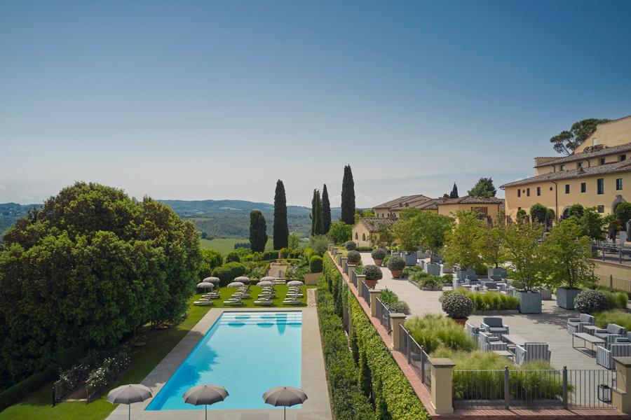 COMO Castello Del Nero heated swimming pool overlooking rolling Chianti hills