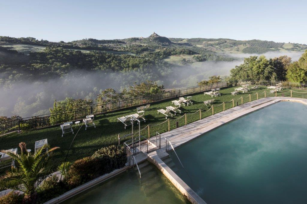 Historic stone facade and gardens of Hotel La Posta