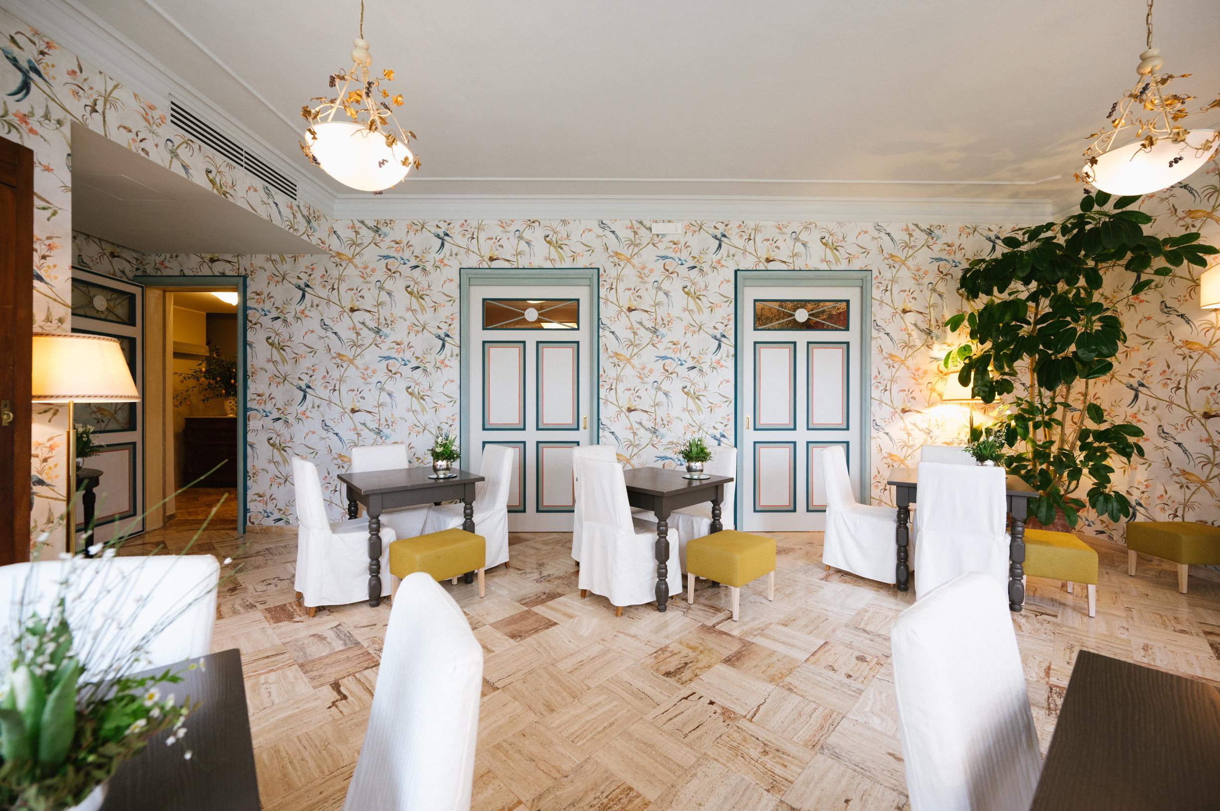 Panoramic glass veranda lounge at Hotel La Posta