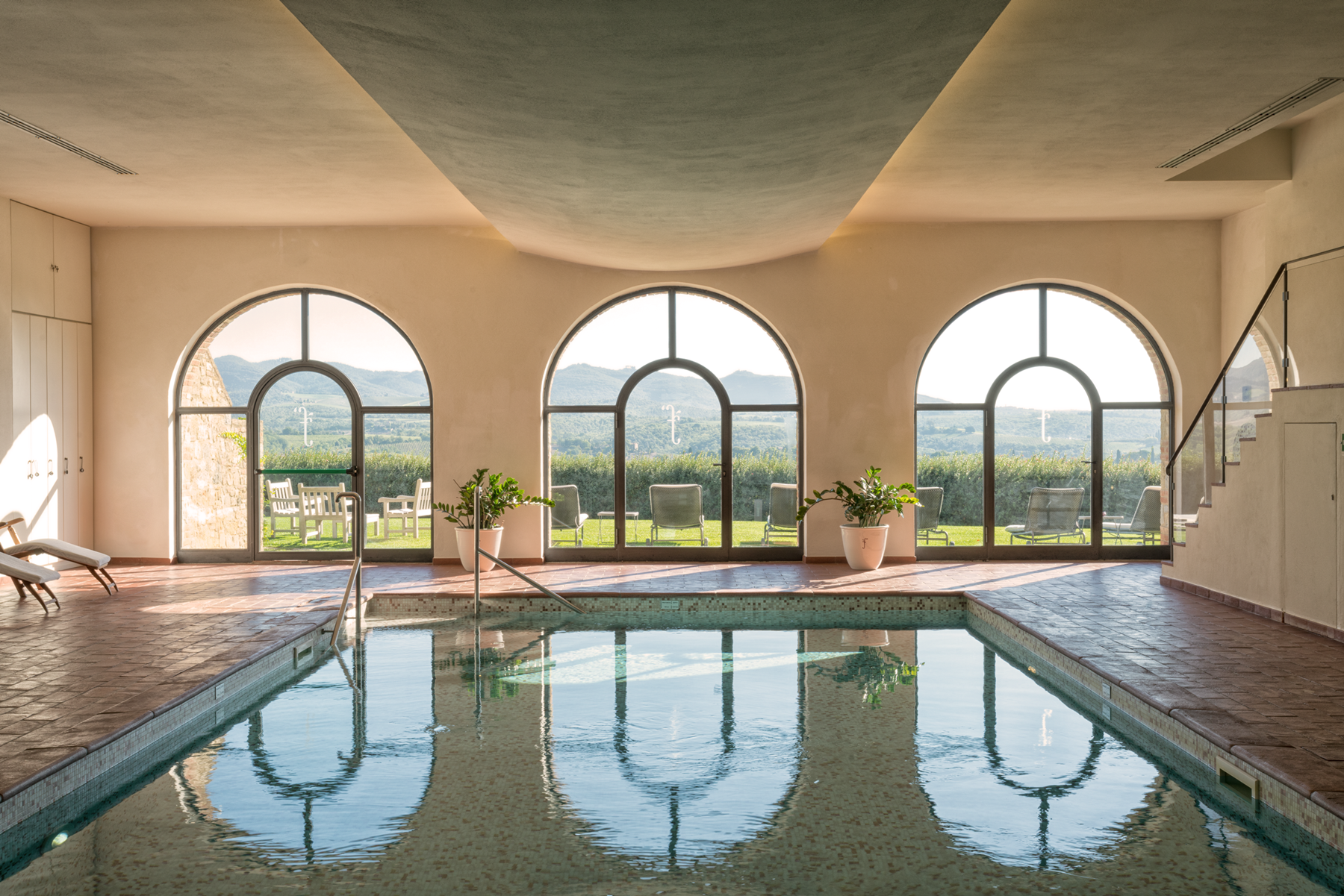 Indoor heated pool and wellness spa under brick arches