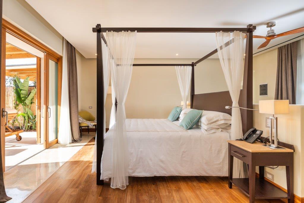 Junior Pool Suite interior featuring private plunge pool patio and minimalist Sicilian luxury